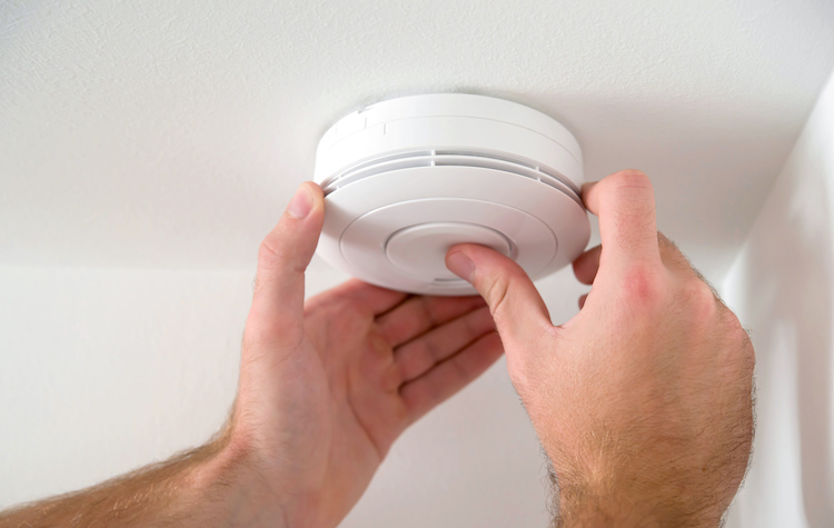 Man Installing Smoke Detector on Ceiling | Jason Wright Electric